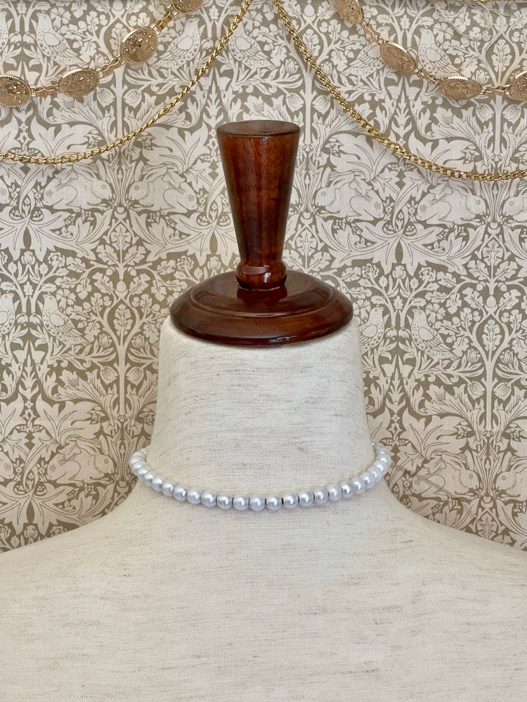 A Handmade Historically Inspired Victorian Pearl Beaded Ribbon Choker Necklace in Burgundy on a mannequin.