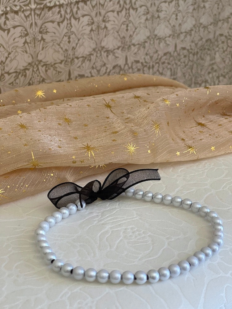 A handmade historically inspired victorian pearl beaded choker necklace in sheer black ribbon.