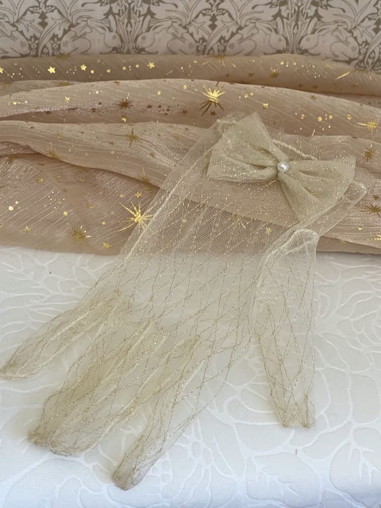 A Pair of Historically Inspired Sheer Lace Gloves with Bow Detail in Champagne Gold. Renaissance, regency, rococo, Victorian era gloves.