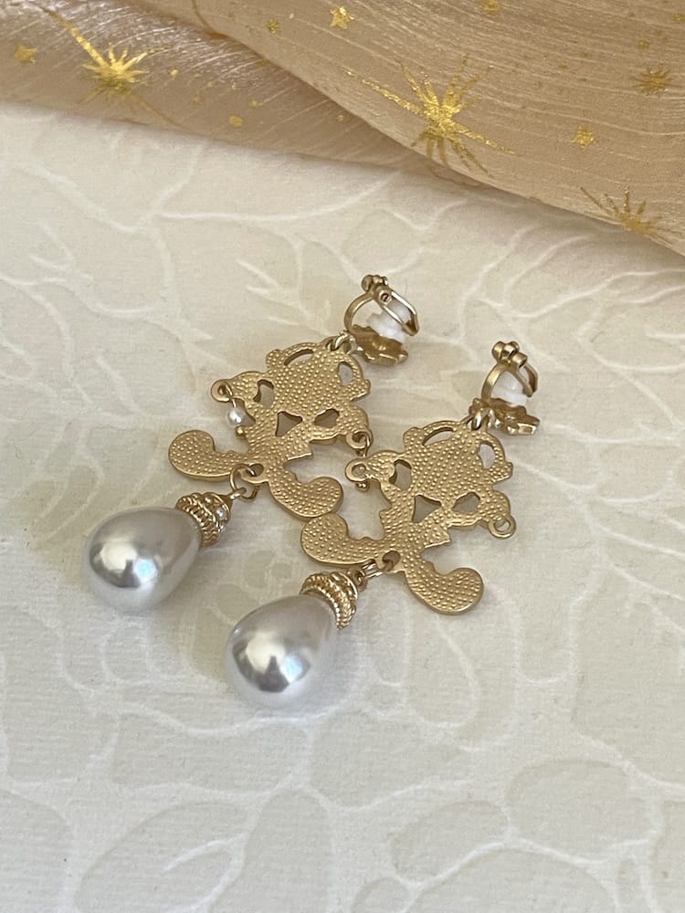 A pair of gold-colored Renaissance Inspired Ornate Flourish Earrings with Pearl Drops.