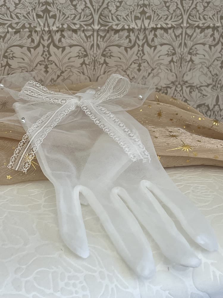 A Pair of Historically Inspired Sheer Gloves with Lace Bow Detail in White, with pearl accents. Perfect for regency, rococo, Victorian, and Edwardian eras.