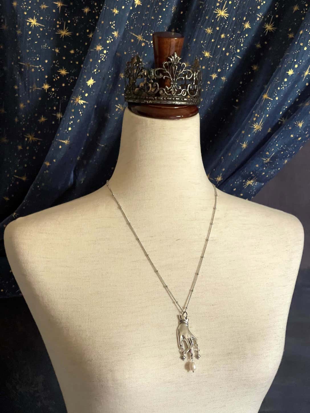 A Handmade Historically Inspired Medieval Hand Pendant Necklace with Real Baroque Pearl Dangle and Celestial Star Charms on a Metal Beaded Chain Necklace in Silver.