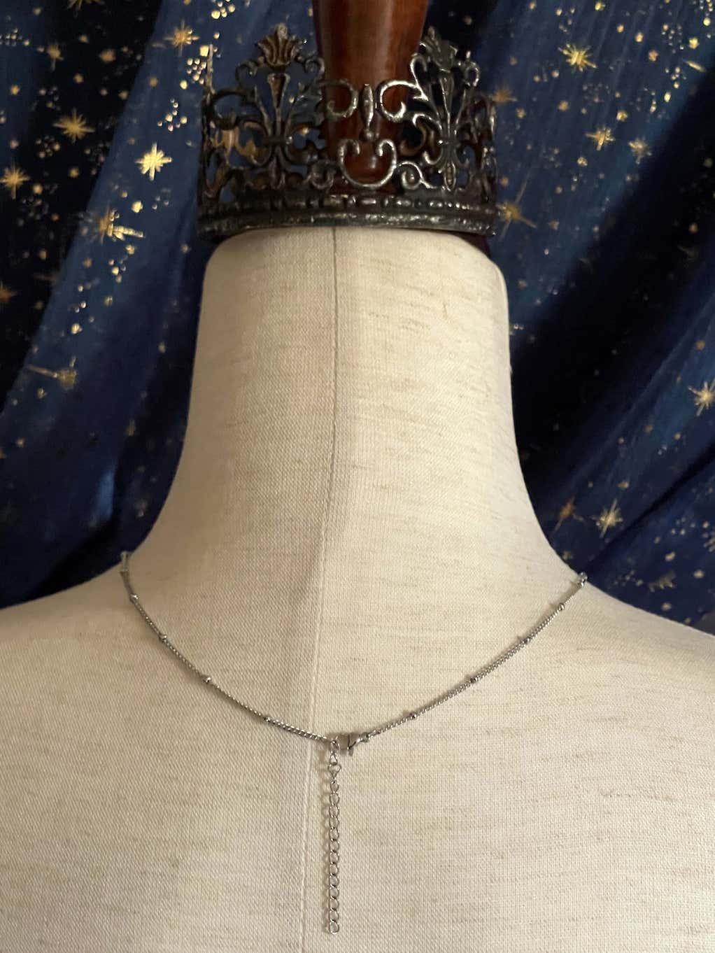 A Handmade Historically Inspired Medieval Hand Pendant Necklace with Real Baroque Pearl Dangle and Celestial Star Charms on a Metal Beaded Chain Necklace in Silver.