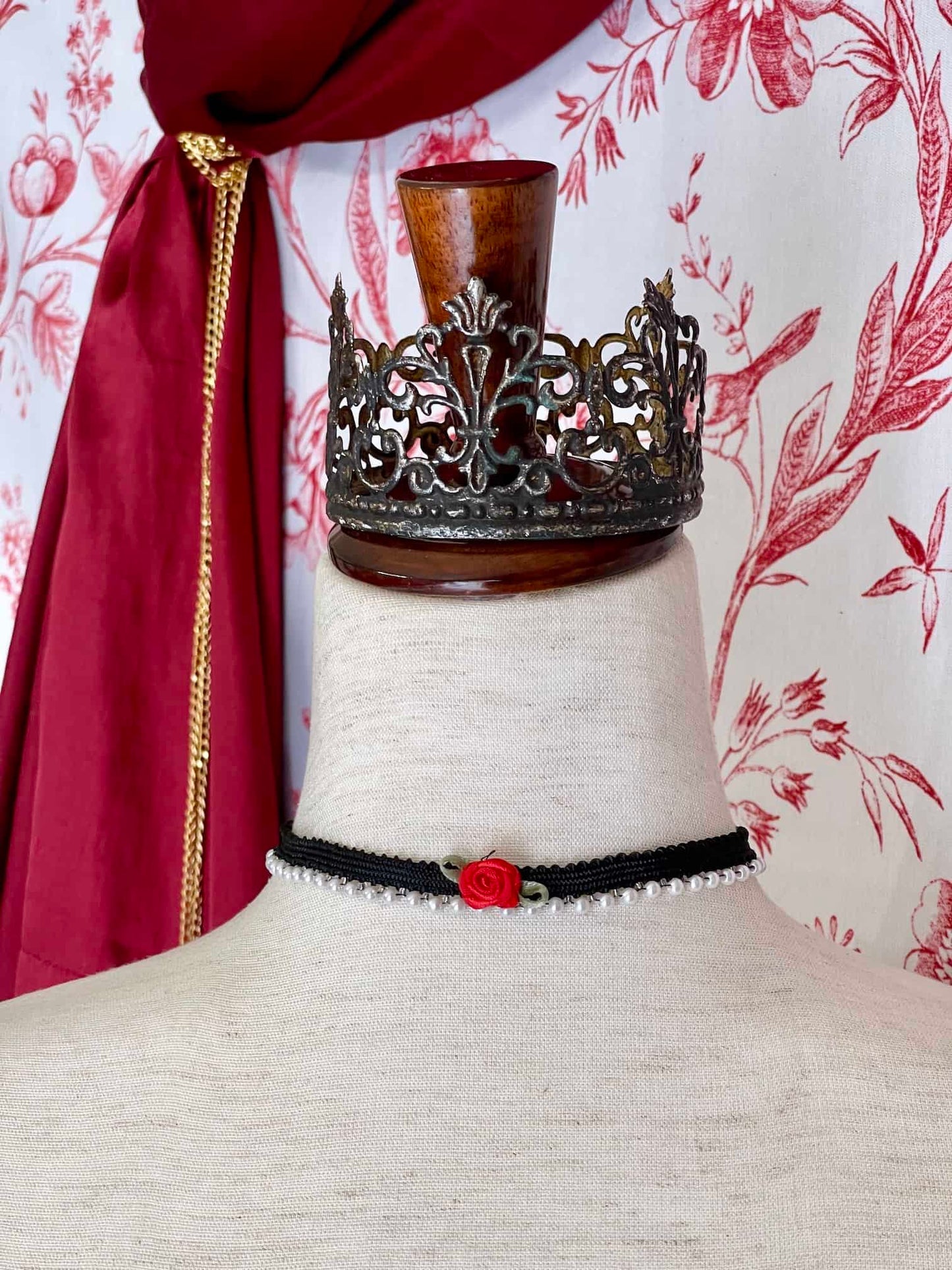 A Handmade Historically Inspired Pearl Lace Choker Necklace in Gothic Black with red rosette applique.