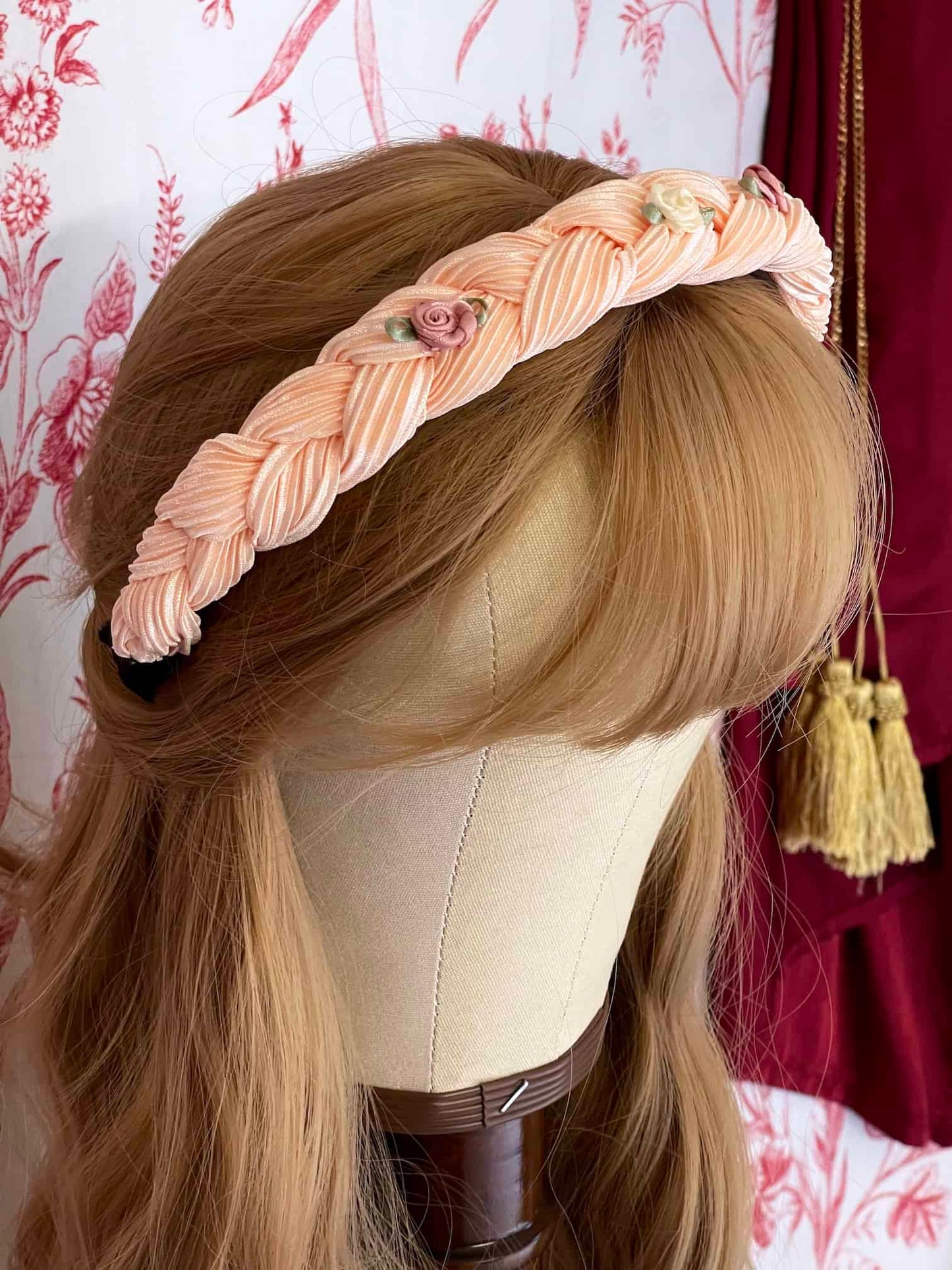 A Historically Inspired Braided Chiffon Rosette Headband in Ballerina Pink, perfect for rococo and regency era fashion.