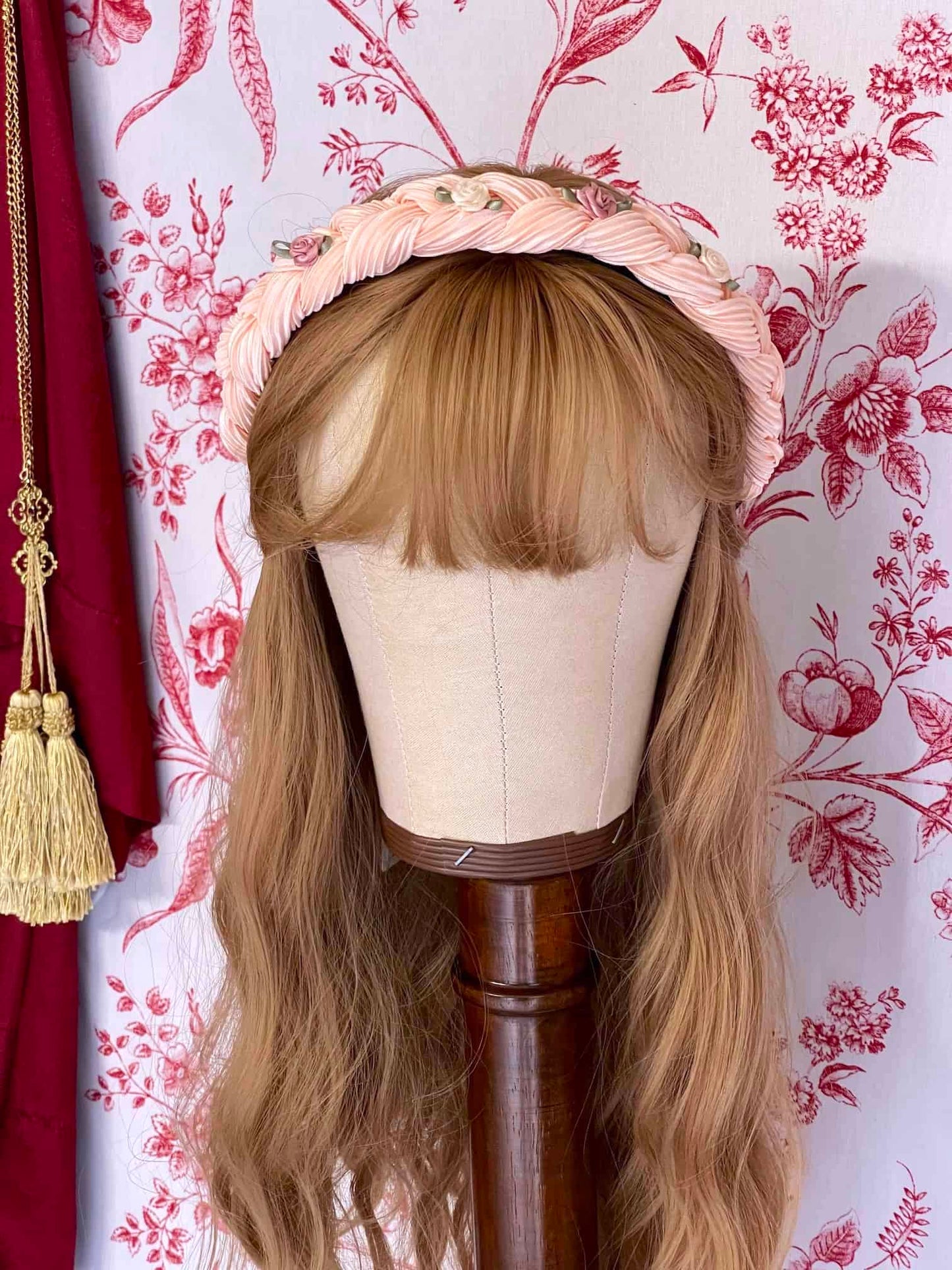 A Historically Inspired Braided Chiffon Rosette Headband in Ballerina Pink, perfect for rococo and regency era fashion.
