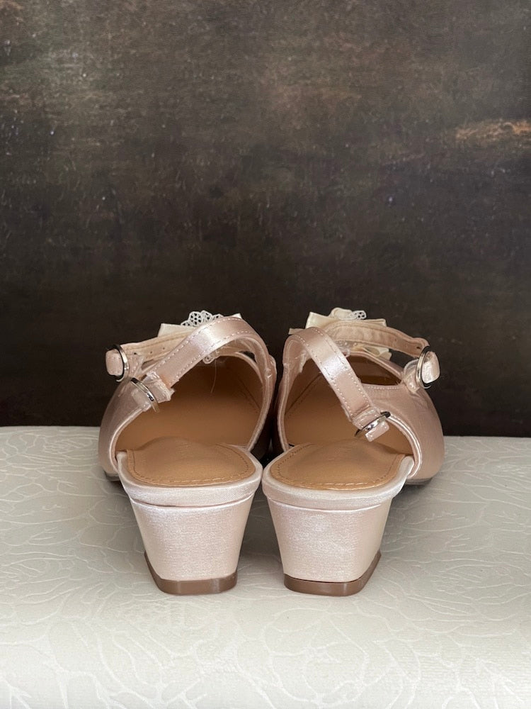 Historically inspired Regency & Rococo Inspired Satin Slipper Heels with Rosette Appliques in Champagne, pictured on a historical painting set.