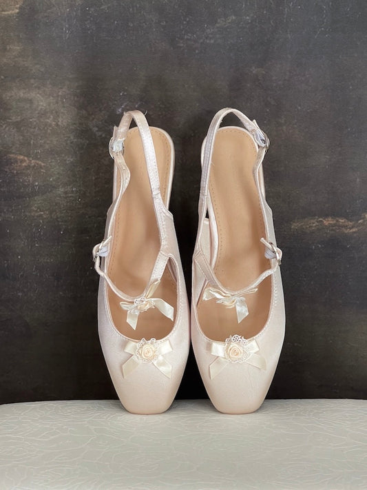 Historically inspired Regency & Rococo Inspired Satin Slipper Heels with Rosette Appliques in Champagne, pictured on a historical painting set.