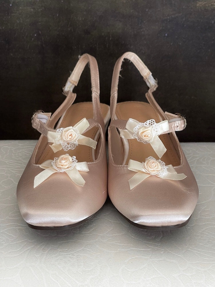 Historically inspired Regency & Rococo Inspired Satin Slipper Heels with Rosette Appliques in Champagne, pictured on a historical painting set.