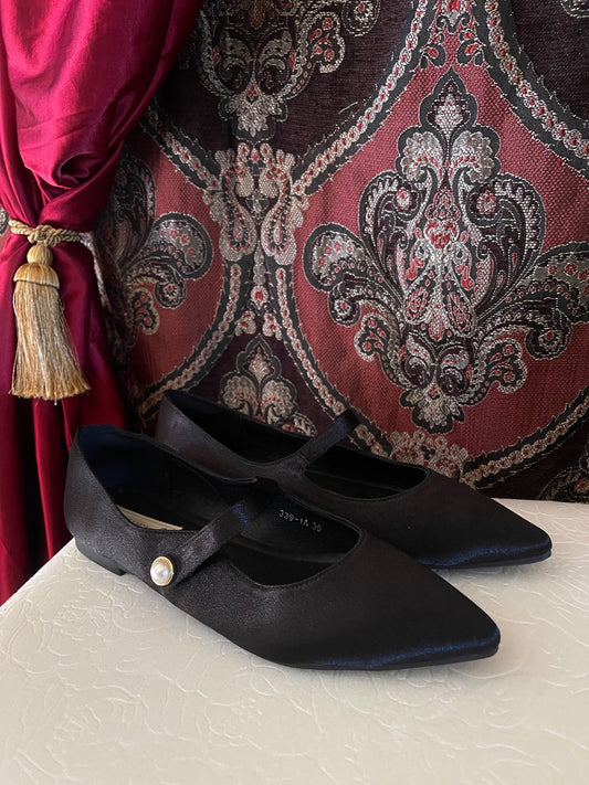 A pair of historically inspired Medieval & Renaissance Satin Pointed Toe Poulaine Flat shoes in Gothic Black with pearl accent.