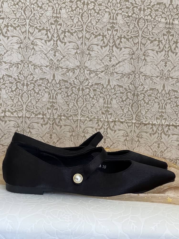 A pair of historically inspired Medieval & Renaissance Satin Pointed Toe Poulaine Flat shoes in Gothic Black with pearl accent.