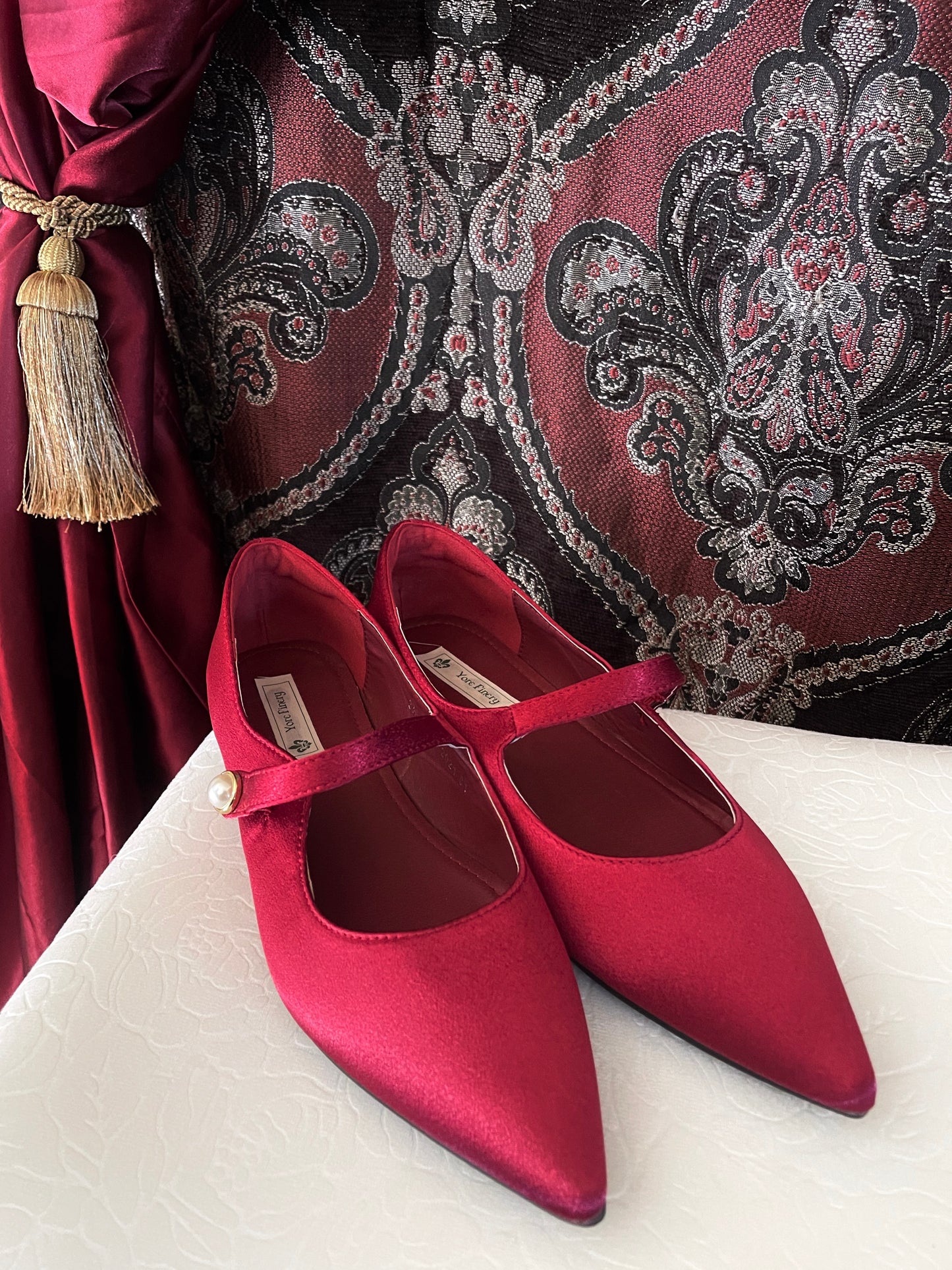 A pair of historically inspired Medieval & Renaissance Satin Pointed Toe Poulaine Flat shoes in Burgundy Red with pearl accent.