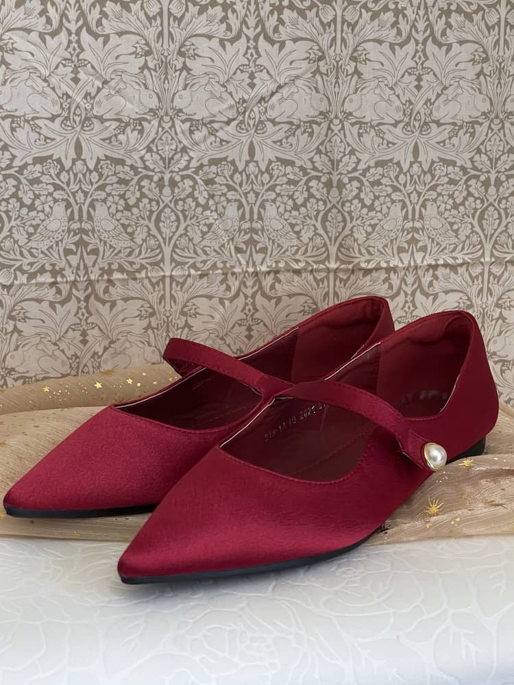 A pair of historically inspired Medieval & Renaissance Satin Pointed Toe Poulaine Flat shoes in Burgundy Red with pearl accent.