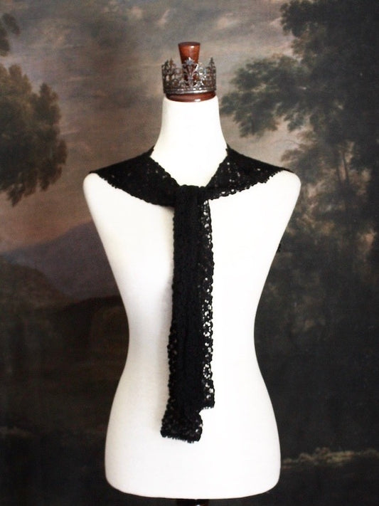 Historically Inspired Floral Crochet Folk Shawl / Capelet in Gothic Black on a mannequin in front of a painting backdrop. Victorian, renaissance, medieval.