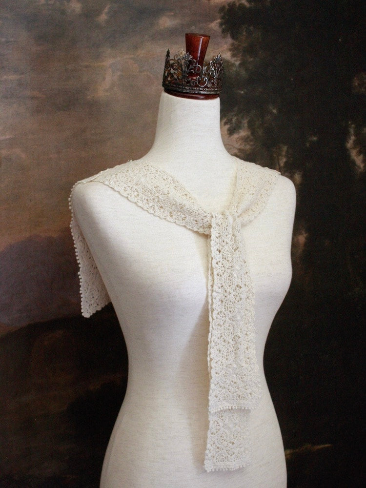 Historically Inspired Floral Crochet Folk Shawl / Capelet in Ivory on a mannequin in front of a painting backdrop. Victorian, renaissance, medieval.