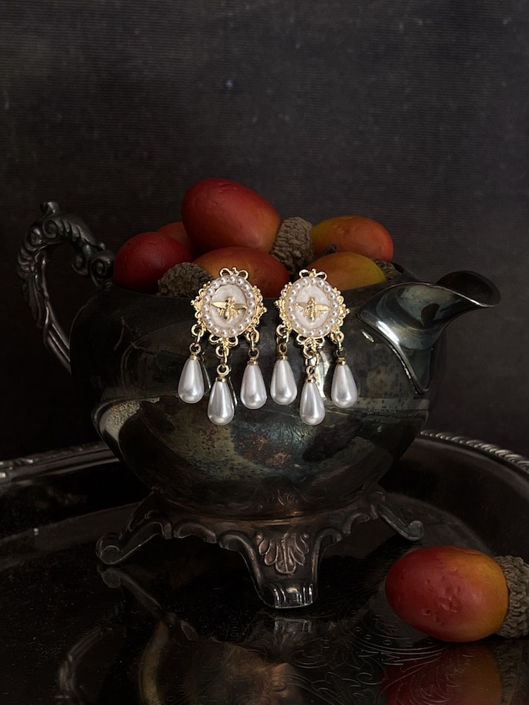 Historically inspired regency earrings with bee cameo, in white and gold, daphne bridgerton accessories on an antique dish.