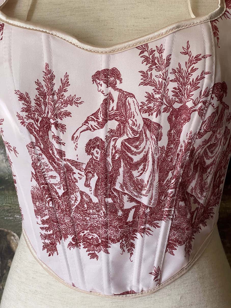 A Historically inspired pair of Baroque & Rococo Era Ivory and Red Countryside Toile de juoy Corset Stays.
