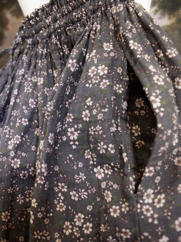 Historically Inspired victorian era peasant turn of the century Printed Floral Cotton Maxi Skirt in Dusty Gray-Blue pictured on a mannequin in front of a classical painting. Pocket.
