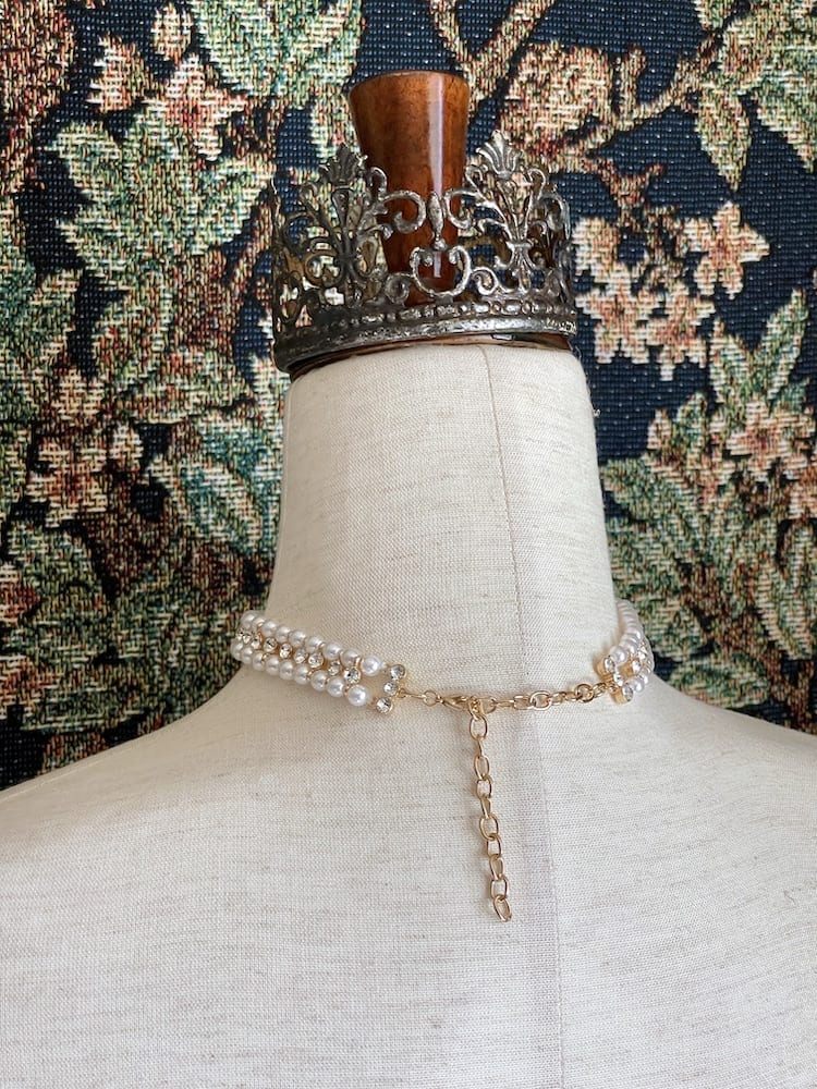 A Historically inspired renaissance baroque tudor rococo regency victorian edwardian style pearl and crystal choker necklace is pictured on a mannequin.