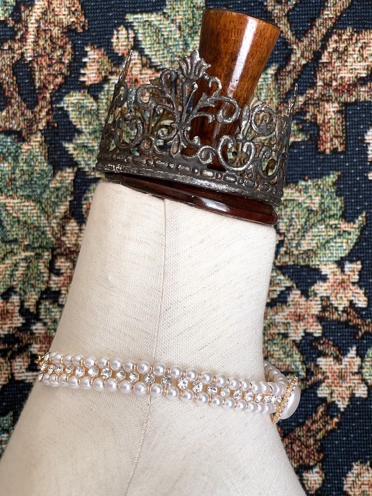 A Historically inspired renaissance baroque tudor rococo regency victorian edwardian style pearl and crystal choker necklace is pictured on a mannequin.