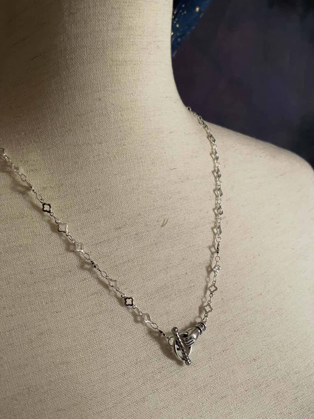 A Handmade Medieval Hand Toggle Clasp Necklace in Silver with Quatrefoil Motif Chain.
