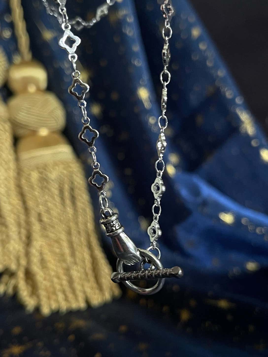 A Handmade Medieval Hand Toggle Clasp Necklace in Silver with Quatrefoil Motif Chain.