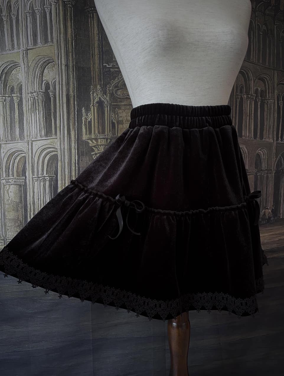 A Historically Inspired Renaissance and Medieval Style Gothic Lace-Trimmed Velvet Mini Skirt in Black with Bow appliques.