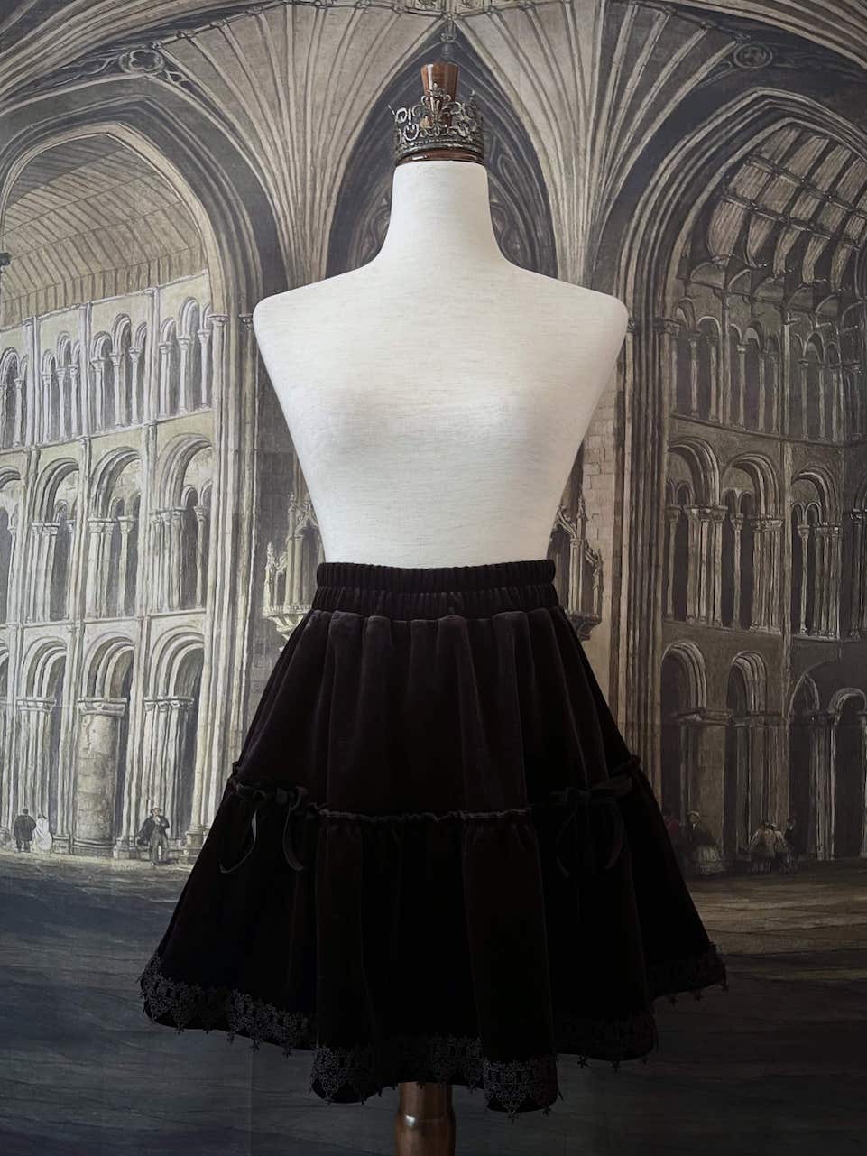 A Historically Inspired Renaissance and Medieval Style Gothic Lace-Trimmed Velvet Mini Skirt in Black with Bow appliques.