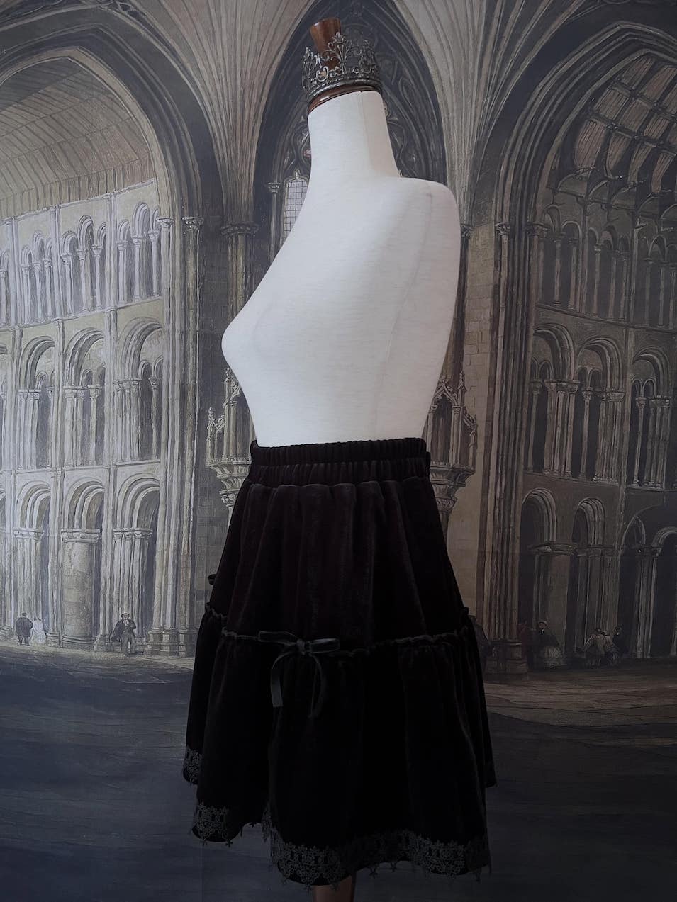 A Historically Inspired Renaissance and Medieval Style Gothic Lace-Trimmed Velvet Mini Skirt in Black with Bow appliques.