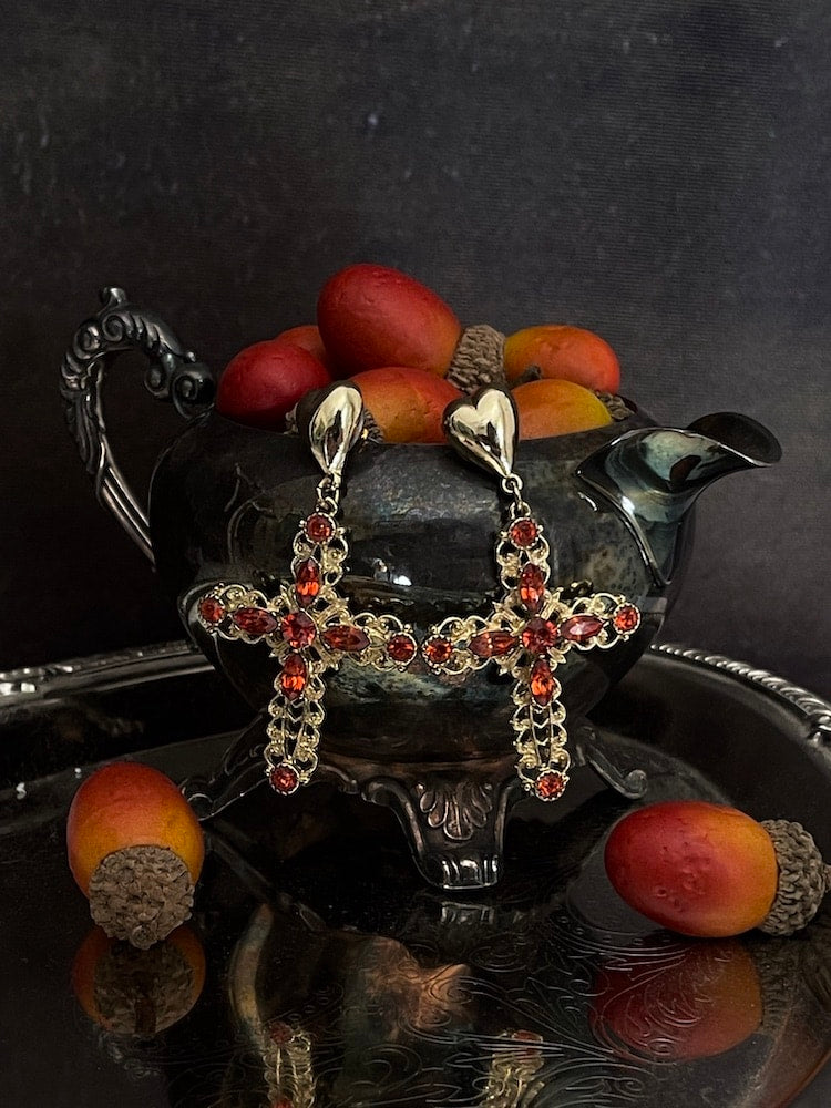 Historically Inspired baroque Ornate filigree Jeweled Cross Earrings in Gold & Red on an autumn display with antique victorian dishes.