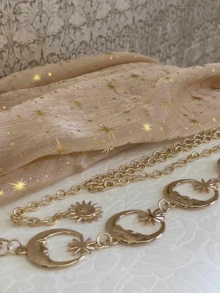 Historical Fantasy Inspired Celestial crescent Moon and Sun Belt in Gold, pictured on a Whimsigoth wizard witch autumn backdrop.