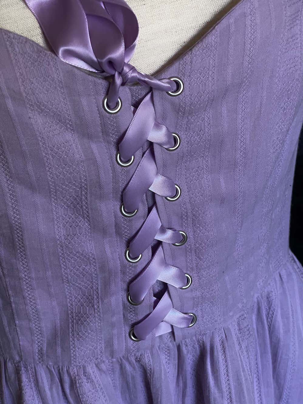 A Medieval Fantasy Corset-Laced Mini Dress in Lavender with Satin Ribbon and Sweetheart Neckline, and Skater Skirt.