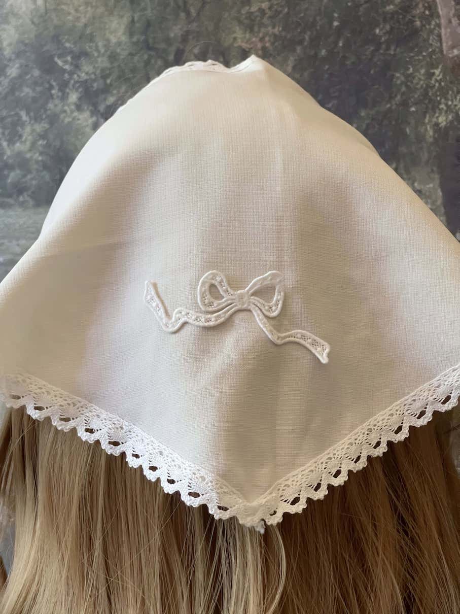 Historically inspired cottagecore coquette victorian babushka style triangle headscarf hair accessory with lace trim and bow accessories.