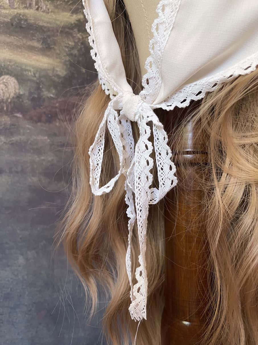 Historically inspired cottagecore coquette victorian babushka style triangle headscarf hair accessory with lace trim and bow accessories.