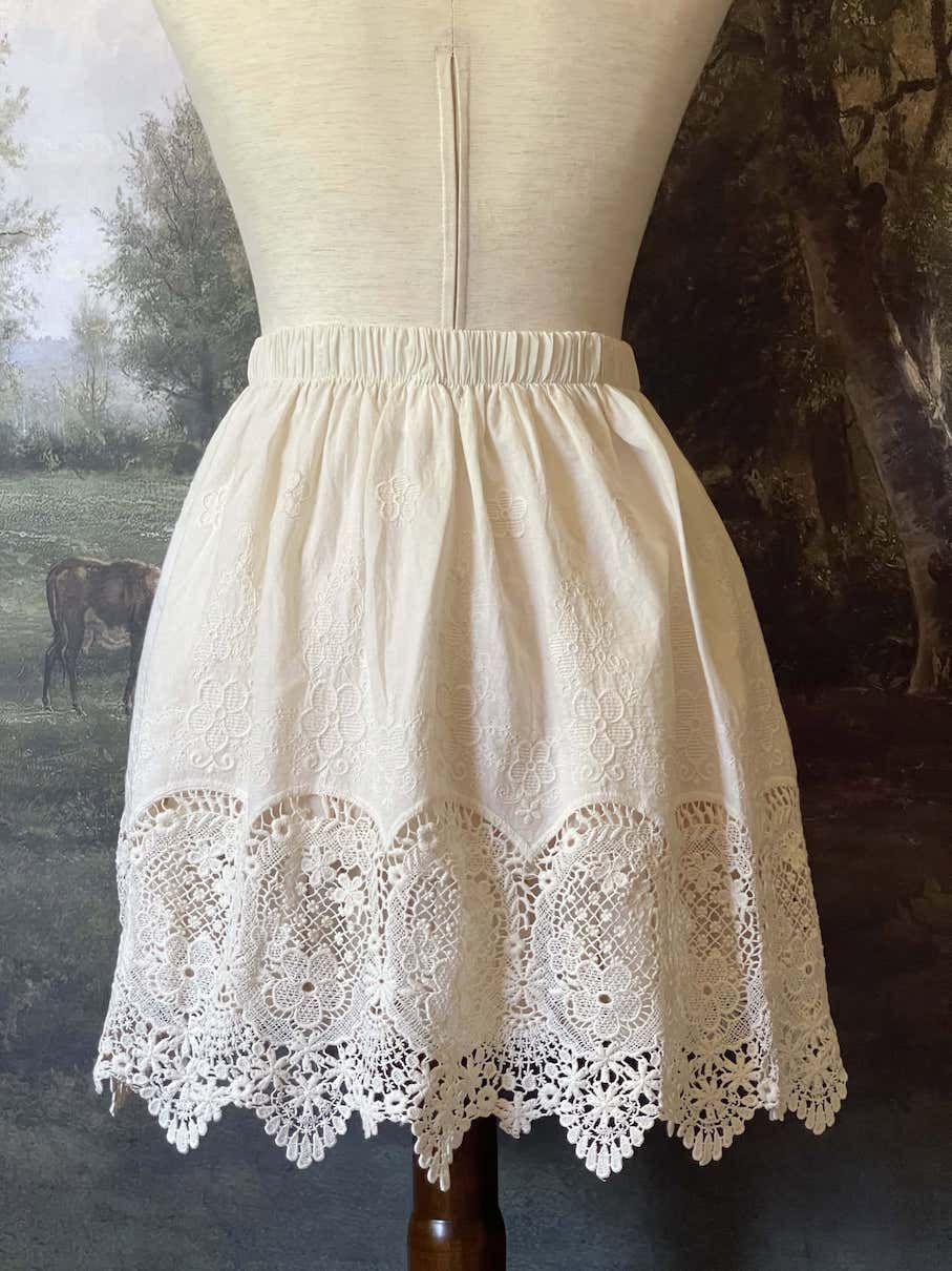 A historical fashion Edwardian & Victorian Inspired Floral Lace-Trimmed Mini Skirt in Ivory.