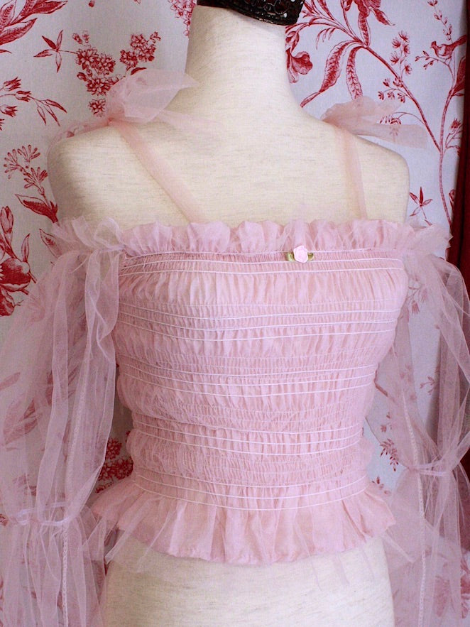 Historically Inspired Victorian Regency and Rococo style ballerina smocked blouse in pastel pink with rosette applique, virago puff sleeves, and off shoulder bow straps.