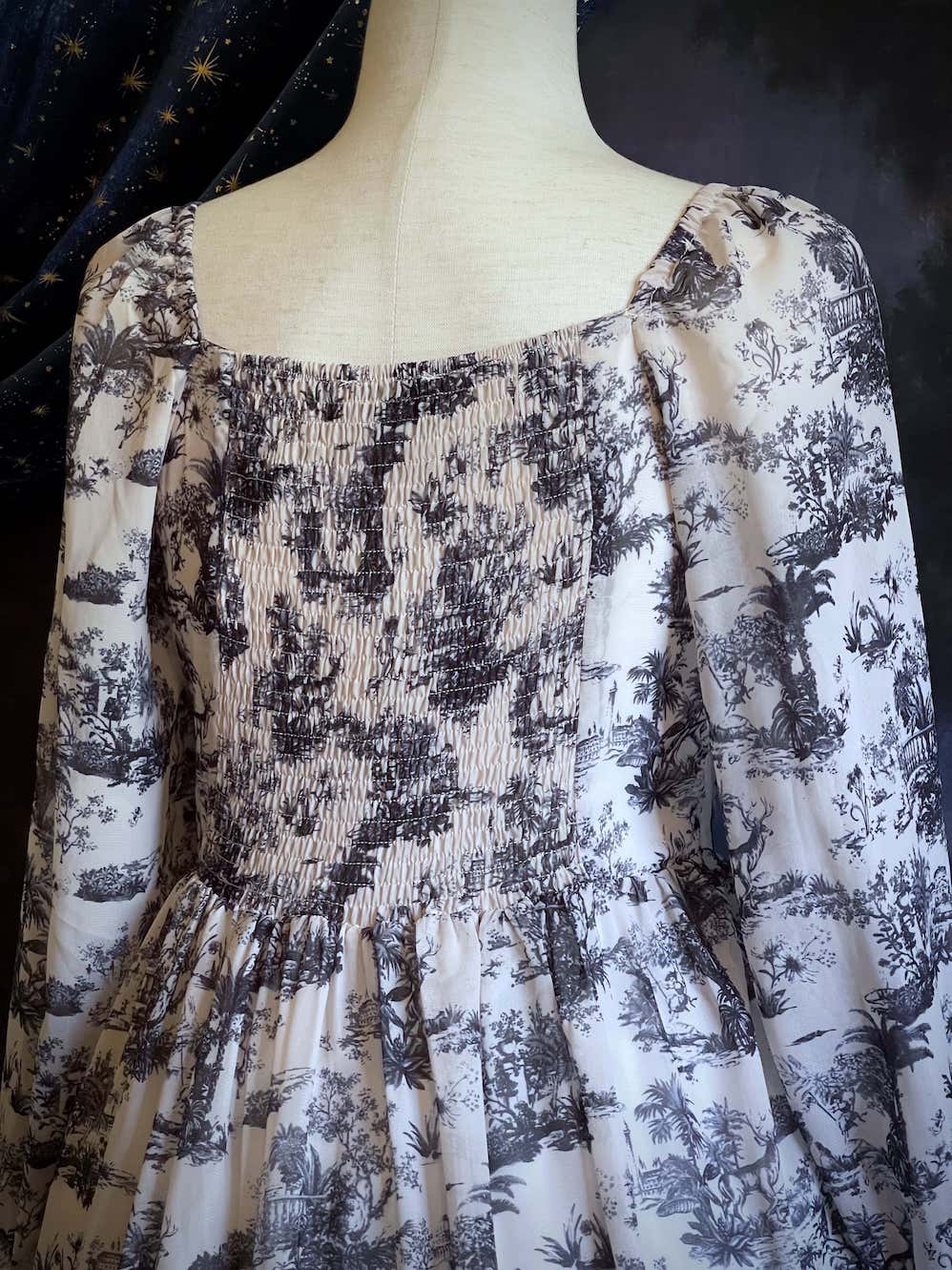 A Historically Inspired Rococo and Baroque style Blue & White Toile Print Bishop Sleeve Mini Dress with Ruffle Trim and Gathered Cuffs
