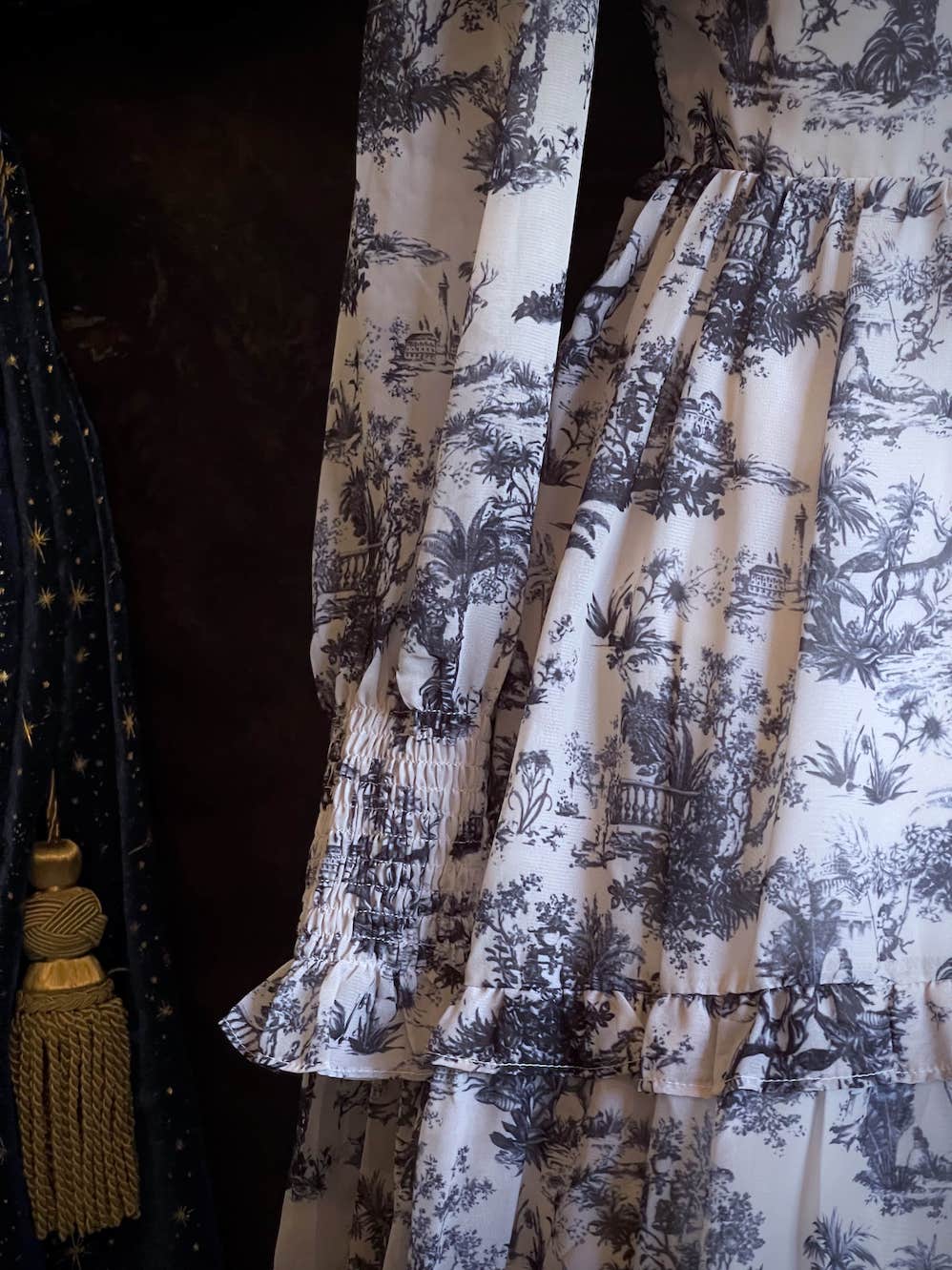 A Historically Inspired Rococo and Baroque style Blue & White Toile Print Bishop Sleeve Mini Dress with Ruffle Trim and Gathered Cuffs