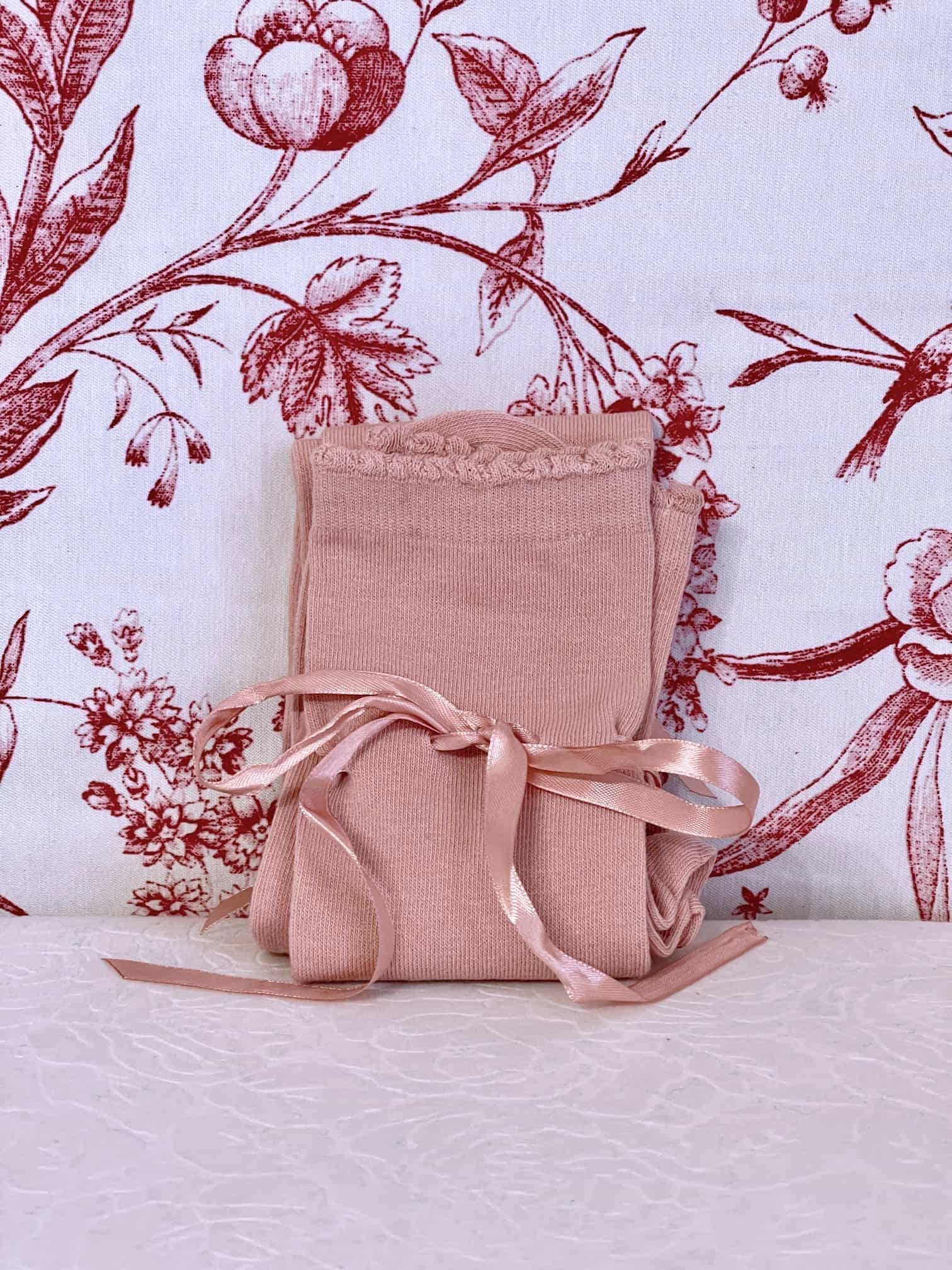 A pair of historically inspired knee high stocking socks in ballerina pink, for edwardian, victorian, regency, rococo, baroque, renaissance, and medieval era fashion.