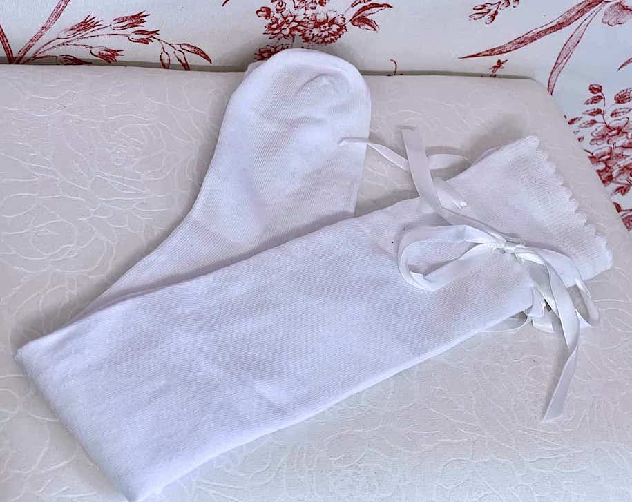A pair of Historically Inspired Cotton Knee-High Socks with Ribbon Lacing in White, for Medieval, Renaissance, Baroque, Rococo, Regency, Victorian, or Edwardian fashion.