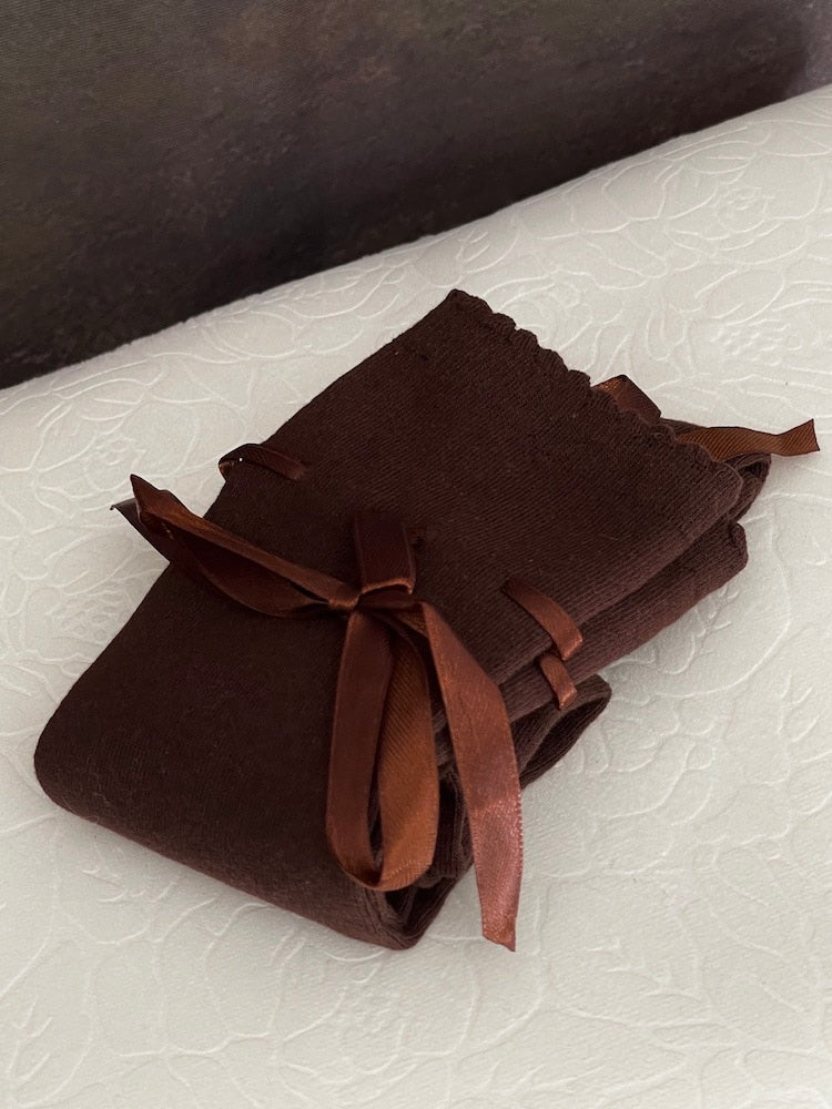 A pair of brown historically inspired knee high stocking socks with ribbon laced bow
