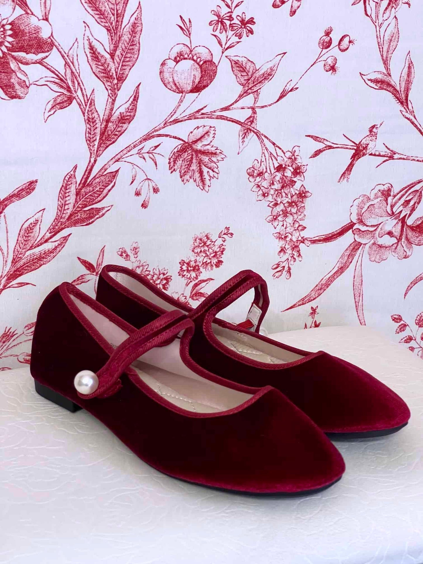 A pair of Historically Inspired Renaissance, Tudor, Baroque era Velvet Slipper Flats in Burgundy with pearl decorative button.