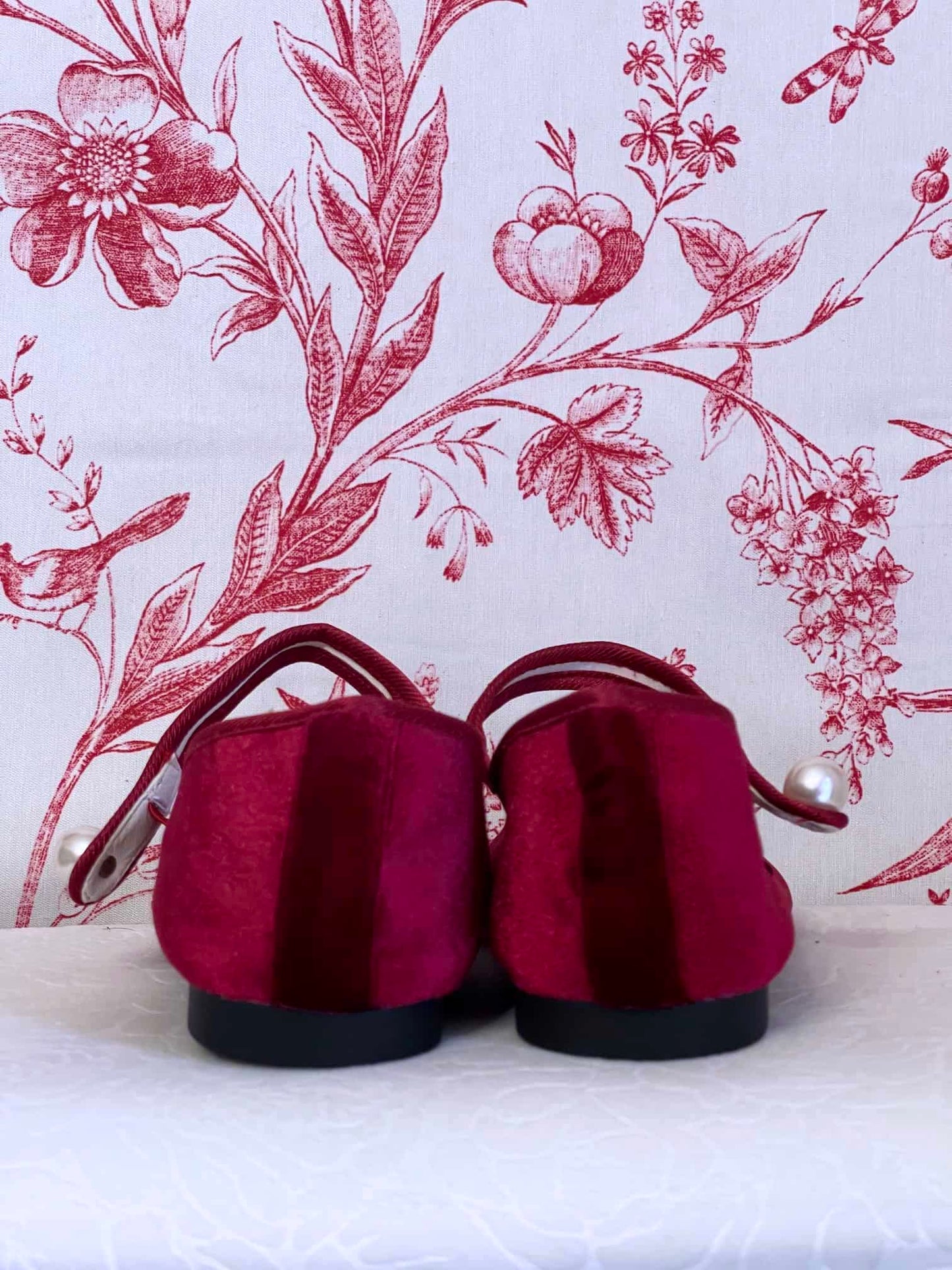A pair of Historically Inspired Renaissance, Tudor, Baroque era Velvet Slipper Flats in Burgundy with pearl decorative button.