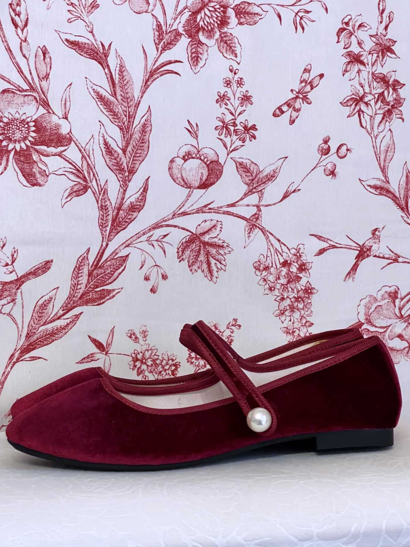A pair of Historically Inspired Renaissance, Tudor, Baroque era Velvet Slipper Flats in Burgundy with pearl decorative button.