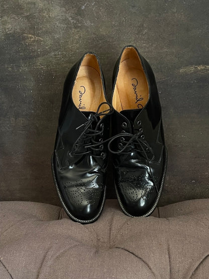 A Pair of historically inspired black patent pleather oxford heels with decretive embossed filigree.   