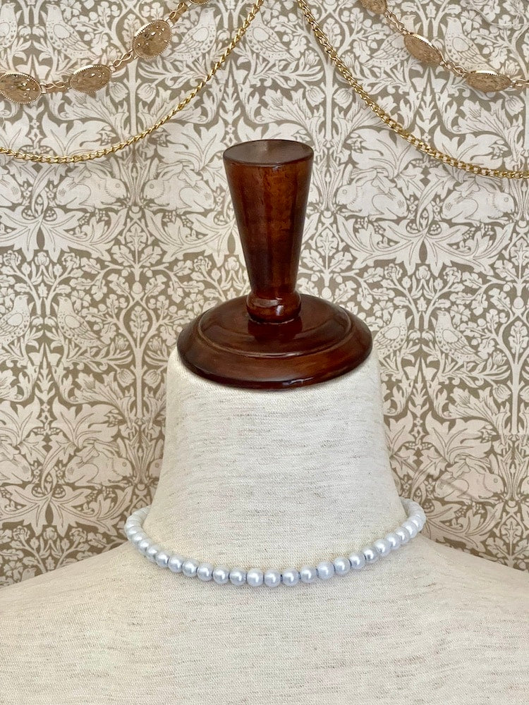 A handmade historically Inspired regency era pearl beaded choker necklace in cornflower blue on a mannequin.