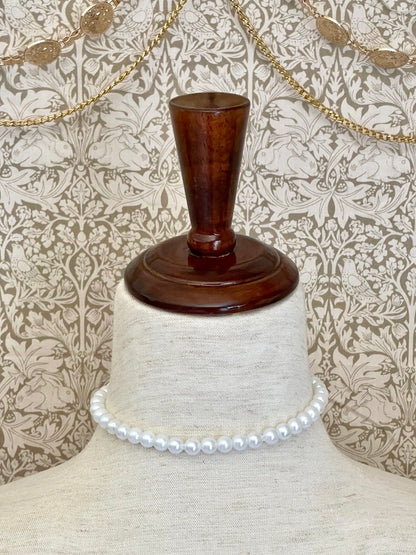 A Handmade historically inspired Regency inspired white pearl beaded ribbon choker necklace is pictured on a mannequin.