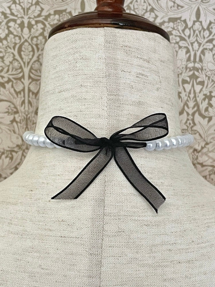 A handmade historically inspired victorian pearl beaded choker necklace in sheer black ribbon.