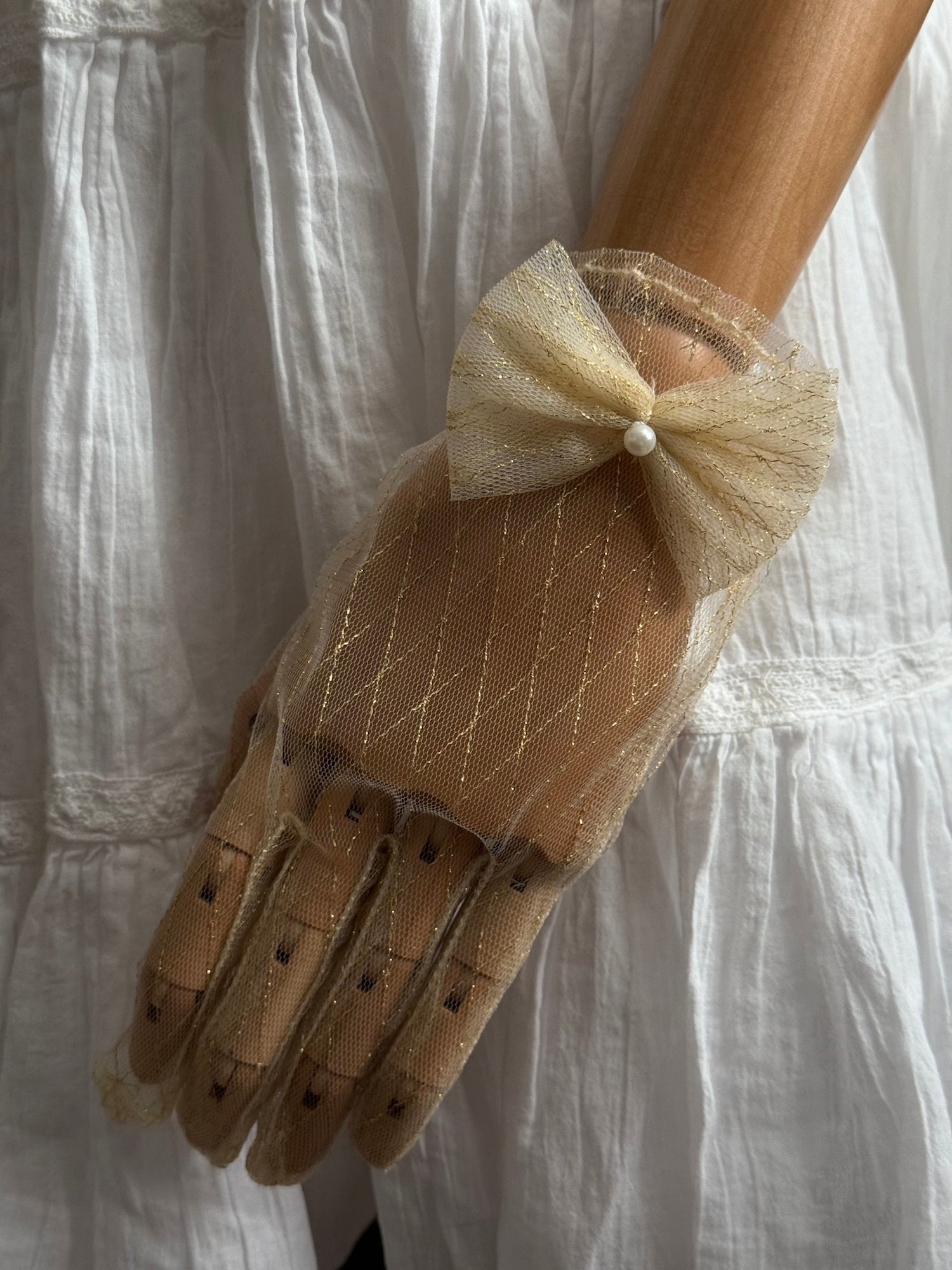 A Pair of Historically Inspired Sheer Lace Gloves with Bow Detail in Champagne Gold. Renaissance, regency, rococo, Victorian era gloves.