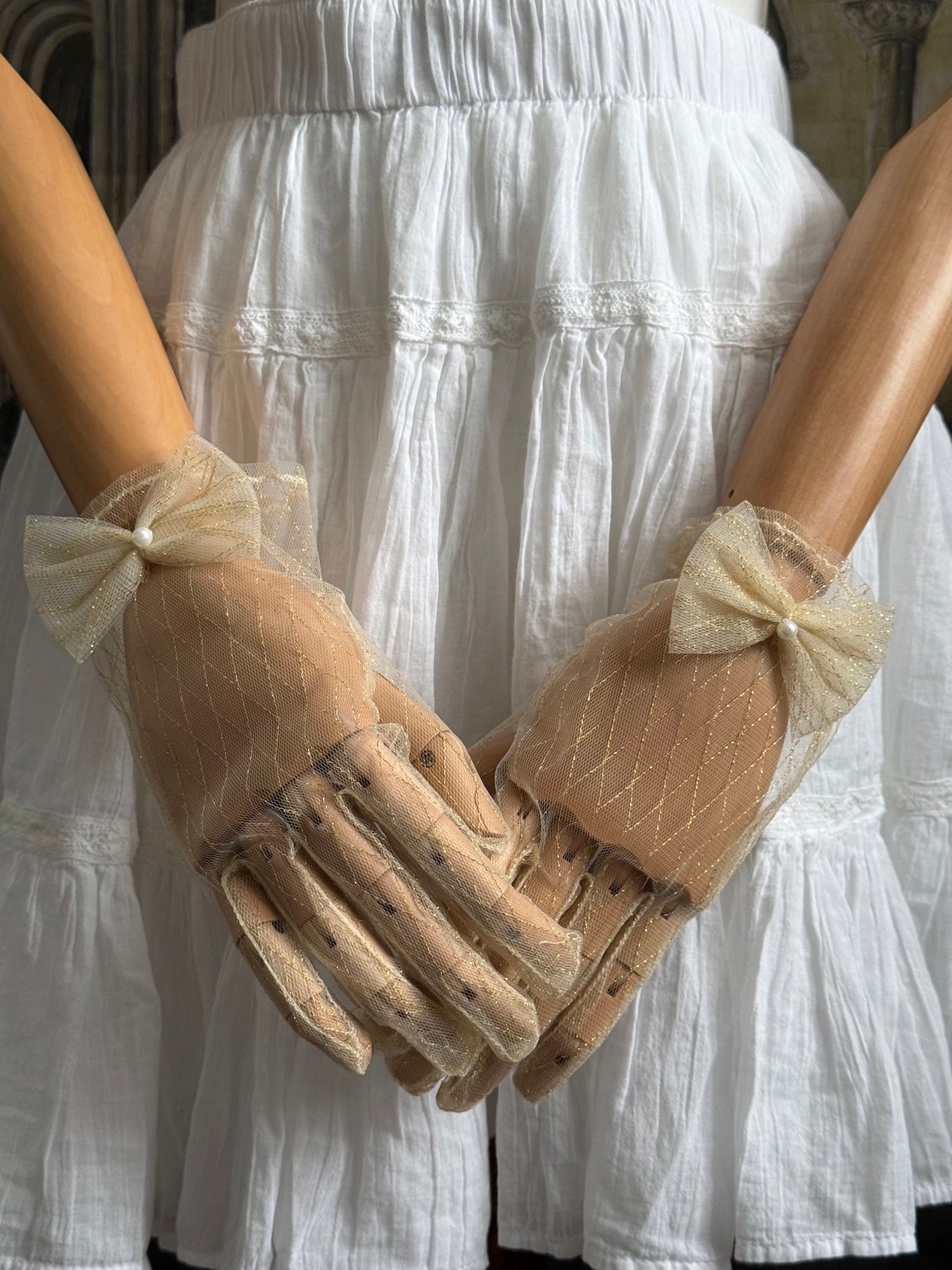 A Pair of Historically Inspired Sheer Lace Gloves with Bow Detail in Champagne Gold. Renaissance, regency, rococo, Victorian era gloves.